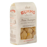 A 500g bag of Rummo Conchiglioni Rigati No.147 pasta from Rummo, featuring cream-colored packaging with red and black text and a clear window displaying the signature shell-shaped pasta inside.
